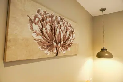 a painting on a wall next to a light fixture at Bluebell Lodge 24 with Hot Tub in Newton Stewart