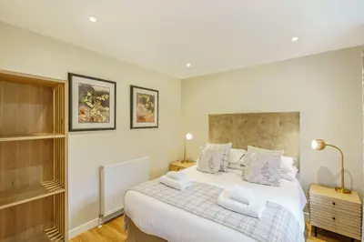 a bedroom with a large bed with two pillows at Birch Lodge 22 with Hot Tub in Newton Stewart
