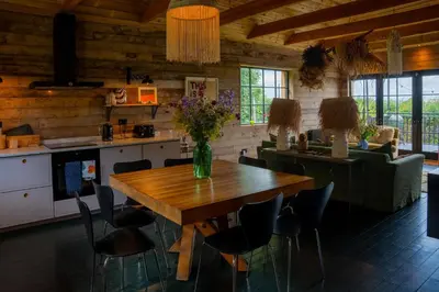 a kitchen and dining room with a wooden table and chairs at The Artist's House at Jupiter Artland in Kirknewton