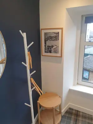 a room with a wooden chair and a table at The Creek-Stone Den in Oban
