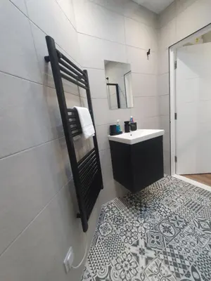 a bathroom with a sink and a mirror at The Creek-Stone Den in Oban