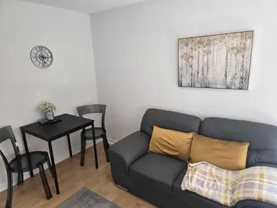 a living room with a couch and a table at Merchantcityflat in Glasgow