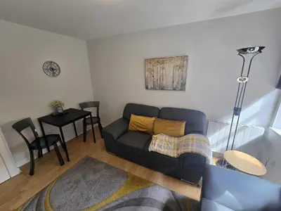 a living room with a couch and a table at Merchantcityflat in Glasgow