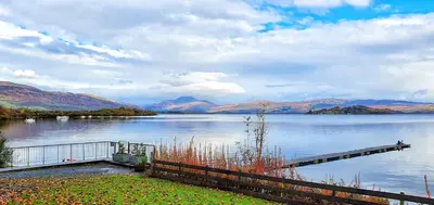 a view of a lake with a wooden dock at Skyline Lodge Loch Lomond Castle Lodges in Balloch