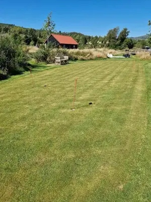 a large grass field with a bench in the middle of it at The Bothy in Stirling