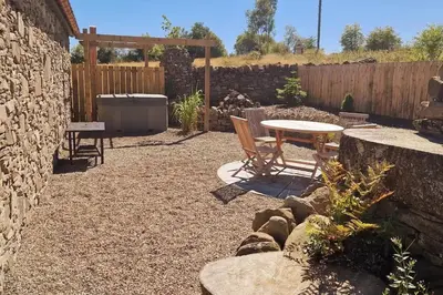 a patio with a table and chairs and a fence at The Bothy in Stirling