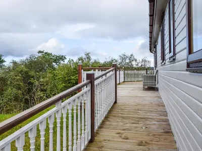 a wooden walkway on the side of a house at Catkin Lodge - Uk39646 in Lunga