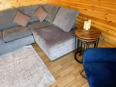 a living room with a couch and a table at Hedgehog's Nest in Bathgate