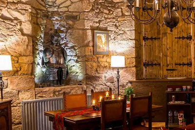 a dining room with a table with candles on it at Craigiehall Temple in Edinburgh