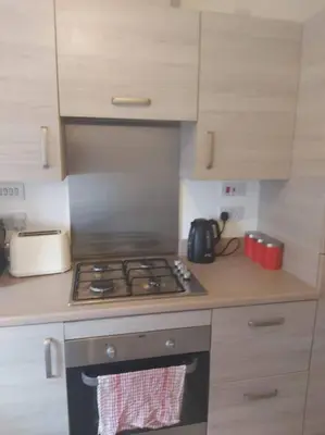 a kitchen with a stove and a counter top at City, Celtic park & Emirates Stadium Apartment, for families or age over 23 in Glasgow