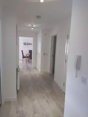 an empty hallway with a dining room and a table at City, Celtic park & Emirates Stadium Apartment, for families or age over 23 in Glasgow