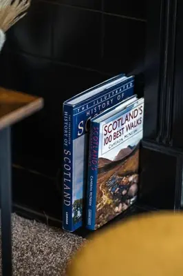 two books sitting next to each other on a table at Finnieston 1-Bed - Walk to Hydro & Bars - Sleeps 2 in Glasgow