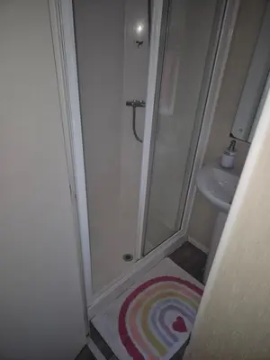 a bathroom with a shower and a sink at 3 bedroom Caravan Craigtara in Ayr
