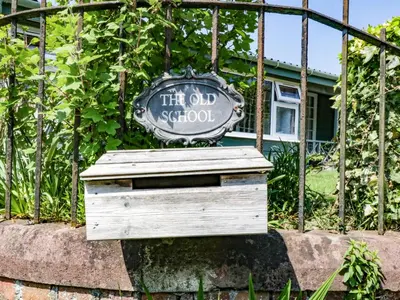 an old school sign sitting on top of a wooden box at The Old School Bike Shed in Stirling