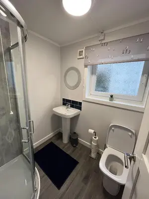a bathroom with a toilet and a sink at Breadalbane Apartment in Oban