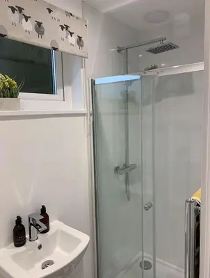 a bathroom with a shower and a sink at Cruachan Cabin in Oban