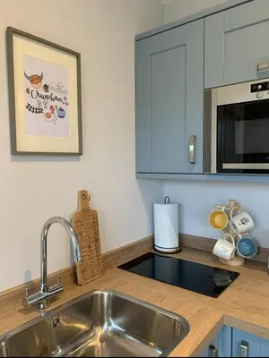a kitchen counter with a sink and a microwave at Cruachan Cabin in Oban