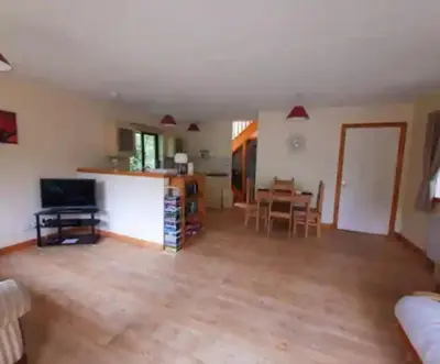 a living room with a kitchen and a dining room at The Singing Heart, TirNaNog Cozy Cottage near Lochgilphead !!HIDDEN GEM!! in Lochgilphead
