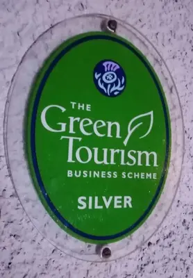 a bottle of green tourism business schemesilver on a table at The Singing Heart, TirNaNog Cozy Cottage near Lochgilphead !!HIDDEN GEM!! in Lochgilphead