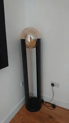a black and white lamp in the corner of a room at Sea Breezes in Oban