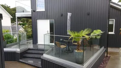 a balcony with a table and chairs on a house at Sea Breezes in Oban