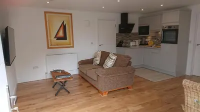 a living room with a couch and a table at Sea Breezes in Oban
