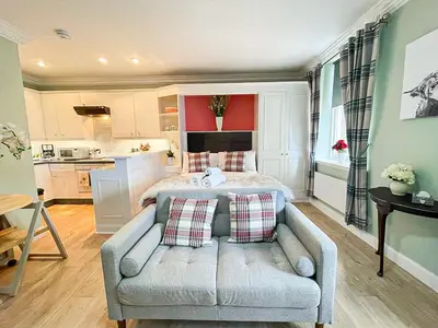 a living room with a bed and a couch at Snug Studio on The Grassmarket, 5mins from Castle in Edinburgh