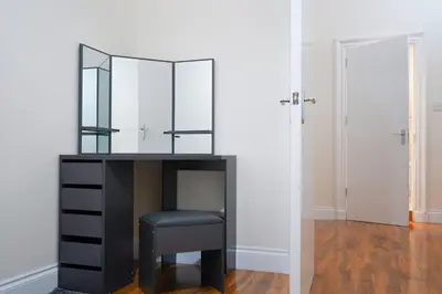 a black desk with a stool and a mirror at Glasgow - 2 Bedroom Apartment in Glasgow