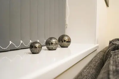 three disco balls sitting on a table in front of a mirror at Glasgow - 2 Bedroom Apartment in Glasgow