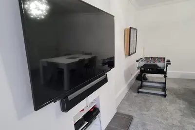 a flat screen tv hanging on a wall in a room at Large 4 bed (sleeps 8) Castle View in Edinburgh