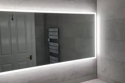 a mirror in a bathroom with a white wall at Large 4 bed (sleeps 8) Castle View in Edinburgh