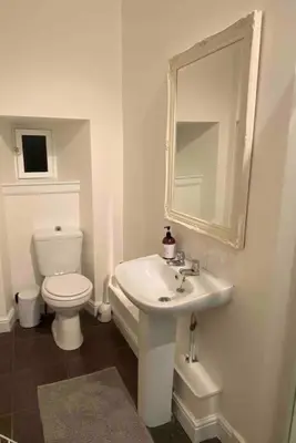 a white bathroom with a toilet and a sink at Large 4 bed (sleeps 8) Castle View in Edinburgh