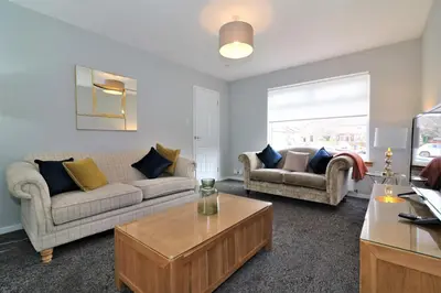 a living room with two couches and a coffee table at Signature - Moore View in Hamilton