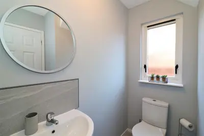 a bathroom with a sink and a mirror at Signature - Moore View in Hamilton