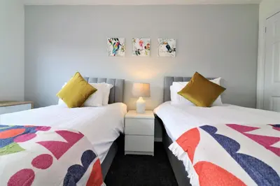 two beds sitting next to each other in a bedroom at Signature - Moore View in Hamilton