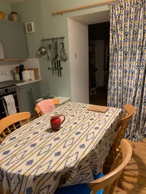a dining room table with a blue and white table cloth at Cosy cottage flat in Inveraray