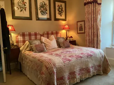 a bedroom with a bed with pillows on it at Loch Gorm House in Bruichladdich