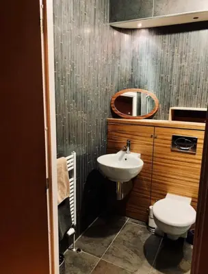 a bathroom with a sink and a toilet and a mirror at Designer Penthouse with Riverviews - G1 Glasgow City Centre, 3 Bedrooms, 2 Bathrooms, 1 Living room / Kitchen. Full Floor, Wrap Around Terrace, Panoramic Views, Off Central Station / Buchanan Street in Glasgow