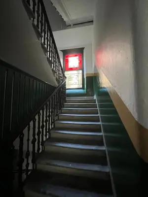 a staircase in a building with a red window at Sauchiehall Street West End Apartment in Glasgow