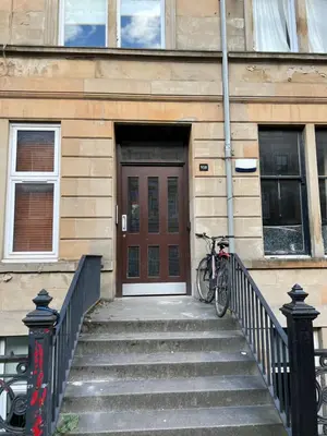 a bike parked in front of a building with a door at Sauchiehall Street West End Apartment in Glasgow