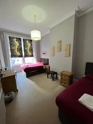a living room with two beds and a couch at Sauchiehall Street West End Apartment in Glasgow