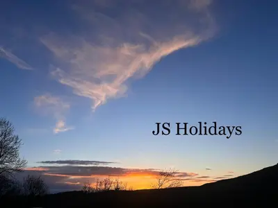 a sunset with the words us holidays in the sky at JS Holidays The Westmorland Lagganhouse in Ballantrae