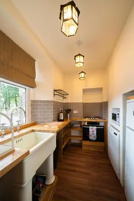 a large kitchen with a sink and a stove at The Bothy, Gallin, Glenlyon, Perthshire in Bridge of Balgie