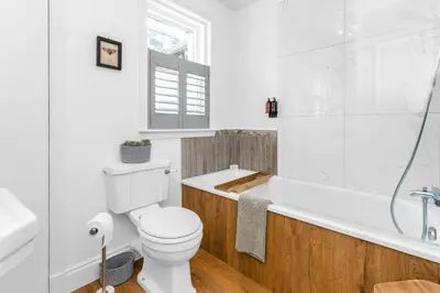 a bathroom with a toilet and a tub and a sink at Beeswing, a Victorian Gem in Biggar in Biggar