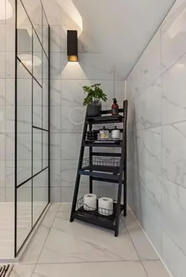 a bathroom with a black shelf with three towels at Little Gleddoch in Dumbarton