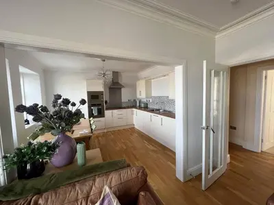 a living room with a couch and a kitchen at Fantastic 3 bedroom holiday home in Millport