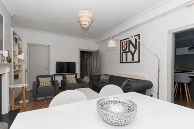 a living room with a couch and a table at Beautiful & Bright 2BD Flat - Haymarket in Edinburgh