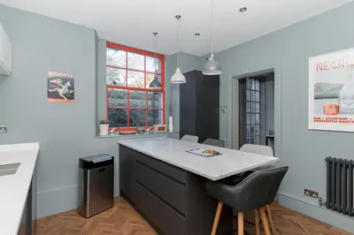 a kitchen with a island with a counter top at Beautiful & Bright 2BD Flat - Haymarket in Edinburgh
