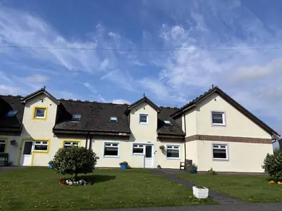 a large white house with black roof at Cunninghame 3 in Beith