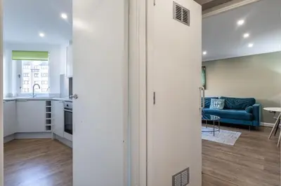 an open door to a kitchen and a living room at ** Modern Merchant City 1 BED Apartment with Free Parking ** in Glasgow